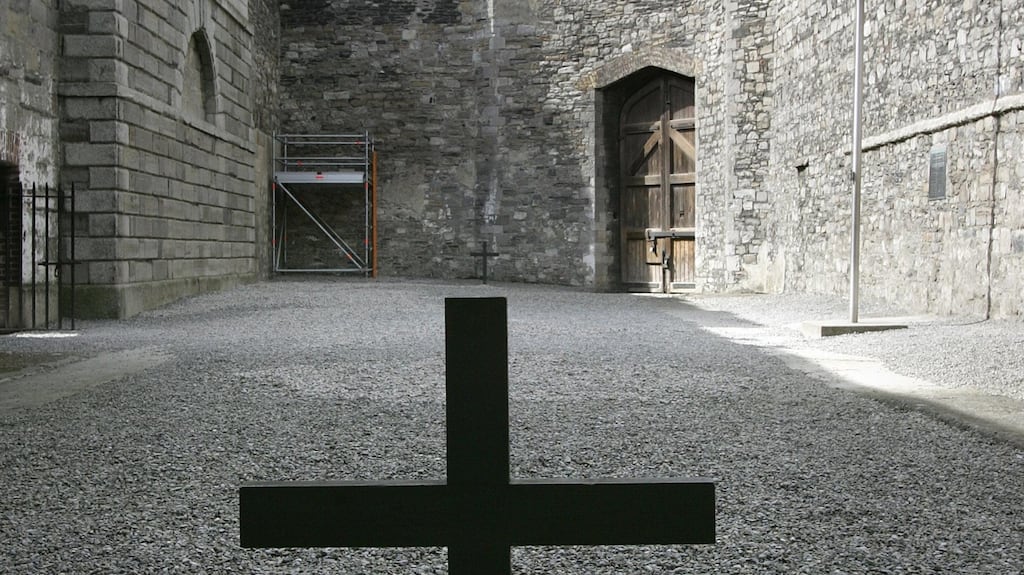 A cross marks the place where James Connolly was executed, sitting in a chair, in the stonebreakers yard at Kilmainham Gaol. photograph: frank miller