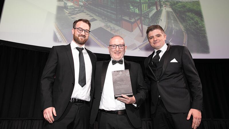 Cathal McGuinness, Director, SAS International, presents the Building of the Year – Commercial award to David O’Brien and Wayne Holmes, McCauley Daye O'Connell Architects.