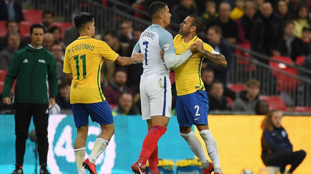 England’s Jake Livermore gets into an altercation with Brazil’s Dani Alves at Wembley. Photograph: PA