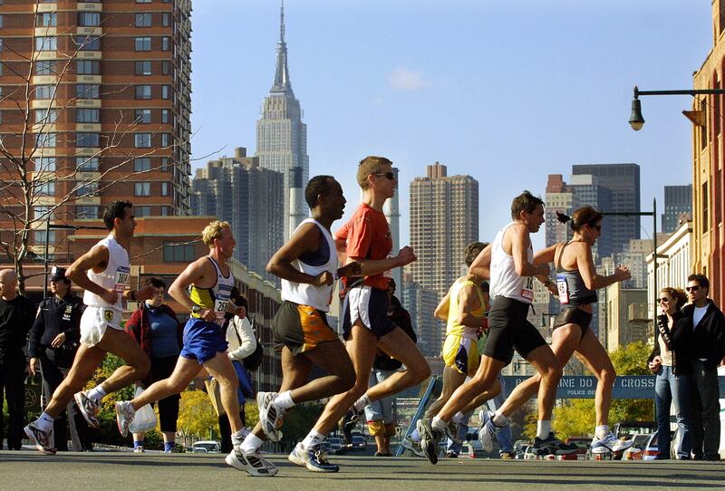 Runners pass through Queens during the New York City Marathon in 2001. The ever-popular event brings a festive air and generates considerable business for the city. Photograph: Mario Tama/Getty Images