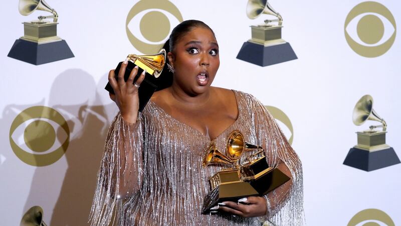Lizzo with her Grammys for best pop solo performance for Truth Hurts, and best urban contemporary album and best traditional R&B performance for Jerome. Photograph: David Swanson/EPA