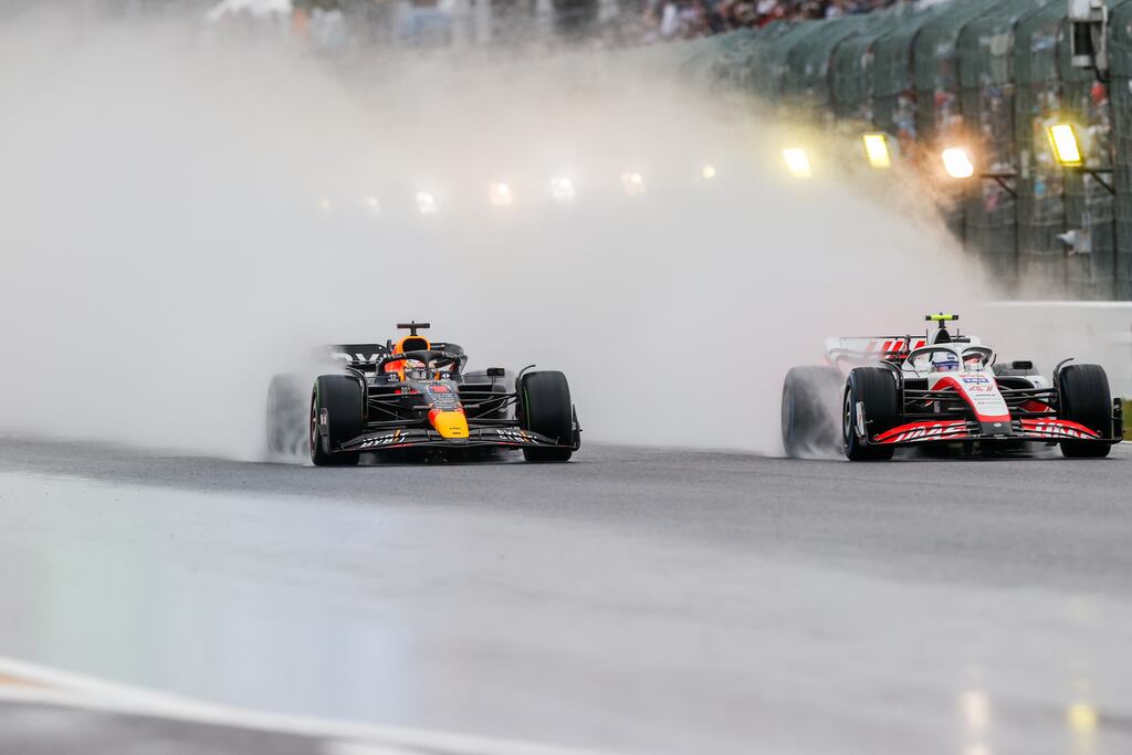 Max Verstappen of Red Bull Racing overtakes Mick Schumacher of Haas in the rain at the Formula One Grand Prix of Japan. Photograph: Peter Fox/Getty Images