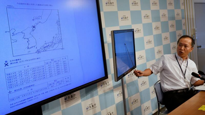 Japan Meteorological Agency (JMA) Earthquake and tsunami observation division director Toshiyuki Matsumori speaks to reporters as screens display the location of a possible explosion in North Korea. Photograph: EPA