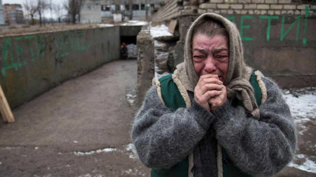 An elderly woman reacts as her acquaintances board a bus to flee due to a military conflict in Debaltseve, Ukraine. The IMF is seeking to negotiate a new multiyear extended fund facility with the troubled country. Photograph: Sergey Polezhaka /Reuters