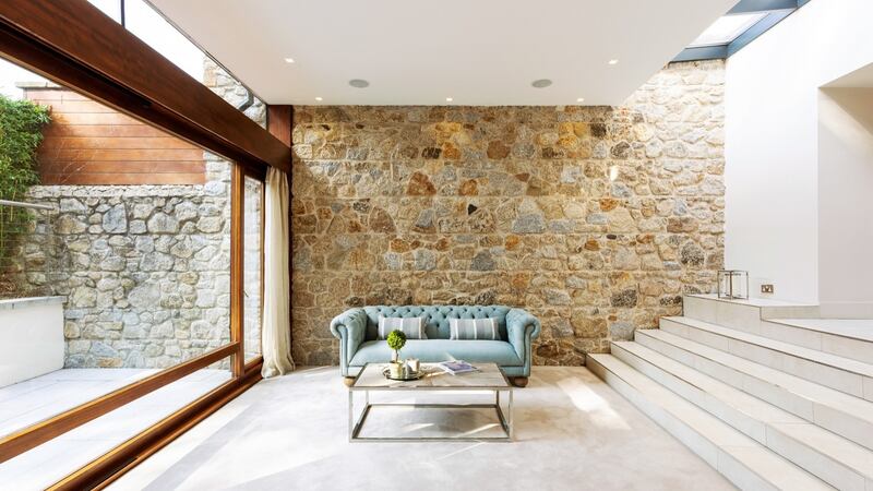 The garden room has an exposed granite wall