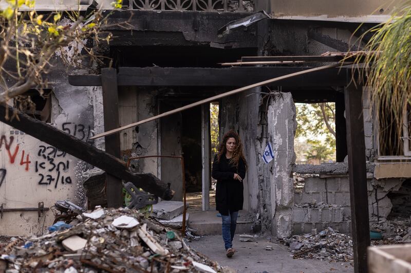 A resident of kibbutz Be'eri walks next to a house destroyed in the Hamas-led attack of October 7th. Photograph: Maja Hitij/Getty Images