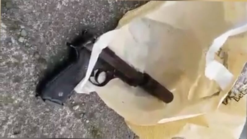 A still image showing a pistol and silencer, taken from eyewitness footage of the scene