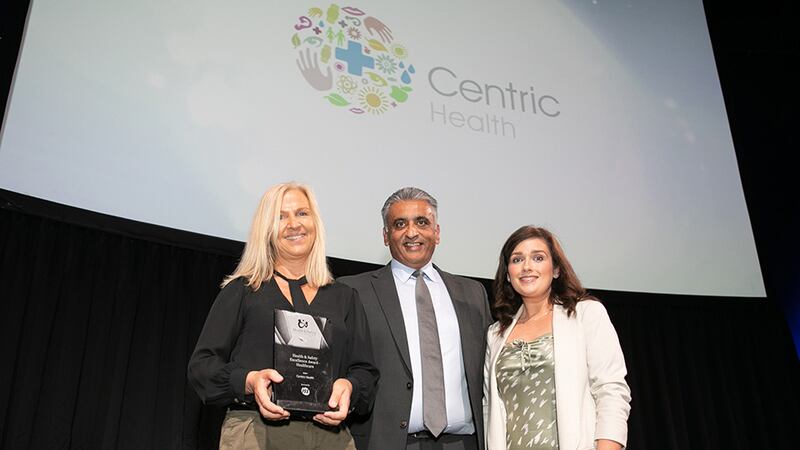 Sanjay Patel, Key Account Director at ISS Facility Services, presents the Health & Safety Excellence Award - Healthcare to Aine Kiely and Marian Mulcahy, Centric Health.