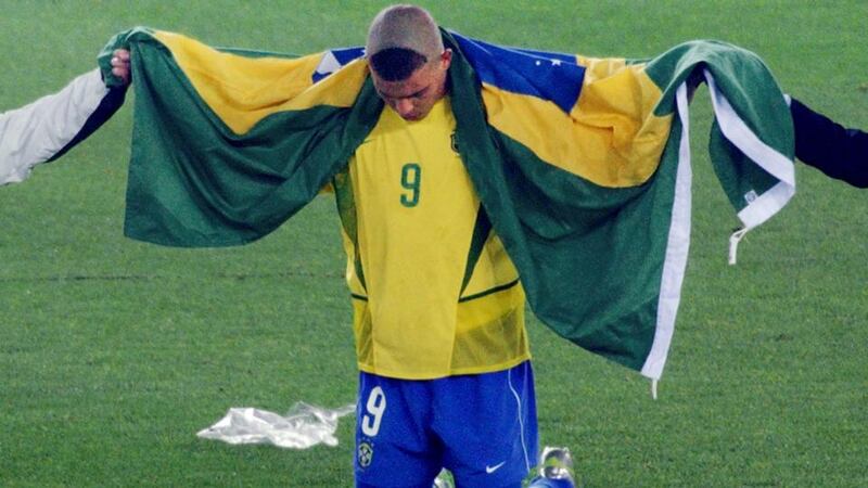 Brazil’s forward Ronaldo, wrapped in the national colors, after Brazil beat Germany 2-0 in Yokohama, Japan, to win the 2002 World Cup final. Photograph: Roberto Schmidt/AFP/Getty Images