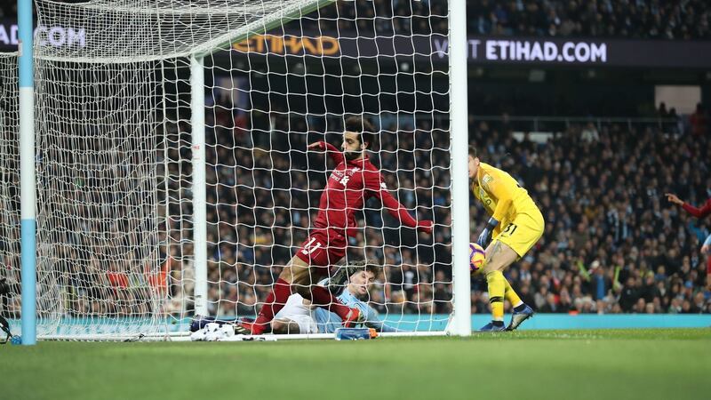 Manchester City defender Aymeric Laporte clears the ball off the line as Liverpool’s Mohamed Salah closes in during the Premier League game at the Etihad stadium. Photograph: Martin Rickett/PA Wire