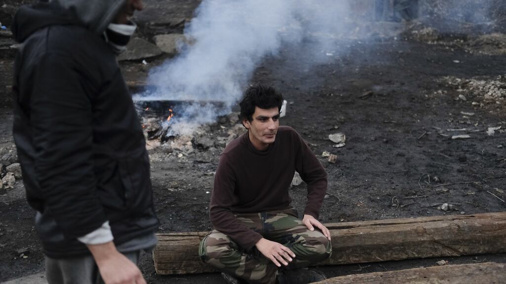 Migrant Ahmad Shakib at the entrance of a derelict customs warehouse in Belgrade, Serbia. Photograph:  Marko Djurica/Thomson Reuters Foundation