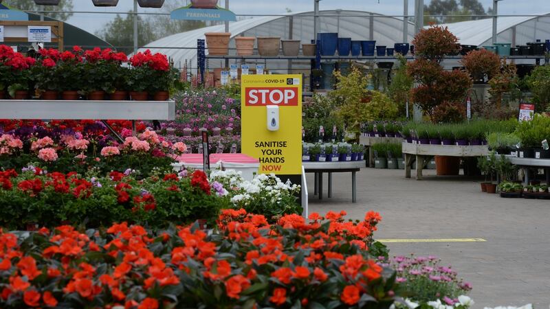 A sign in the garden centre asking people to stop and sanitise their hands. Photograph: Alan Betson