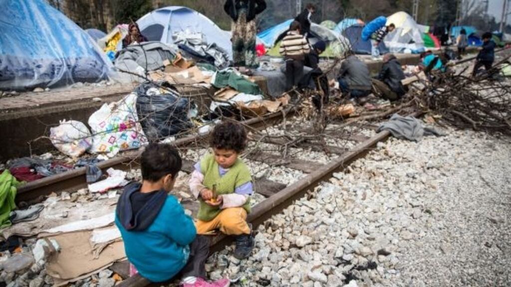 Children play on the railway tracks at the Idomeni refugee camp on the Greek border with Macedonia. Thousands of migrants are stranded at the camp. Photograph: Matt Cardy/Getty Images