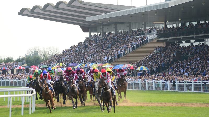 Runners passing the packed stands with a circut to race. Photograph: PA