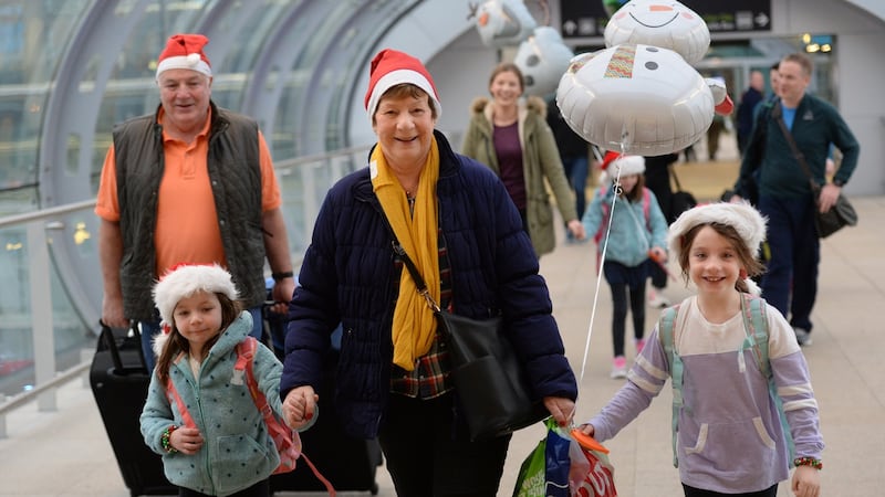 Frances McGlynn, from Belgard, Tallaght after meeting grandchildren Elena, Monica and Clare arriving for Christmas, at Dublin Airport. Photograph: Dara Mac Dónaill / The Irish Times