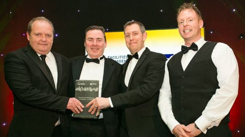 Eoin Manley, Group Facilities Manager and Acting H&S, Dalata Hotel Group presents the Innovation in Technology & Systems – Providers award to Derick Murphy, Eanna Mac Giolla Phadraig and Aidan Murphy, iGuide Mobile Applications
