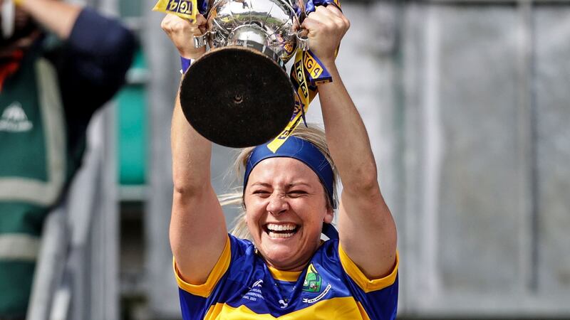Wicklow’s Sarah Jane Winders lifts the trophy after her side’s win over Antrim. Photograph: Laszlo Geczo/Inpho