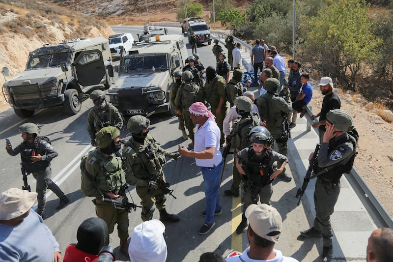 Palestinian farmers are confronted by Israeli security forces after their harvest was disrupted by Israeli settlers and halted by the security forces in Sa'ir village, near the Israeli occupied West Bank city of Hebron on Thursday. Photograph: Mosab Shawer/Middle East Images/AFP via Getty