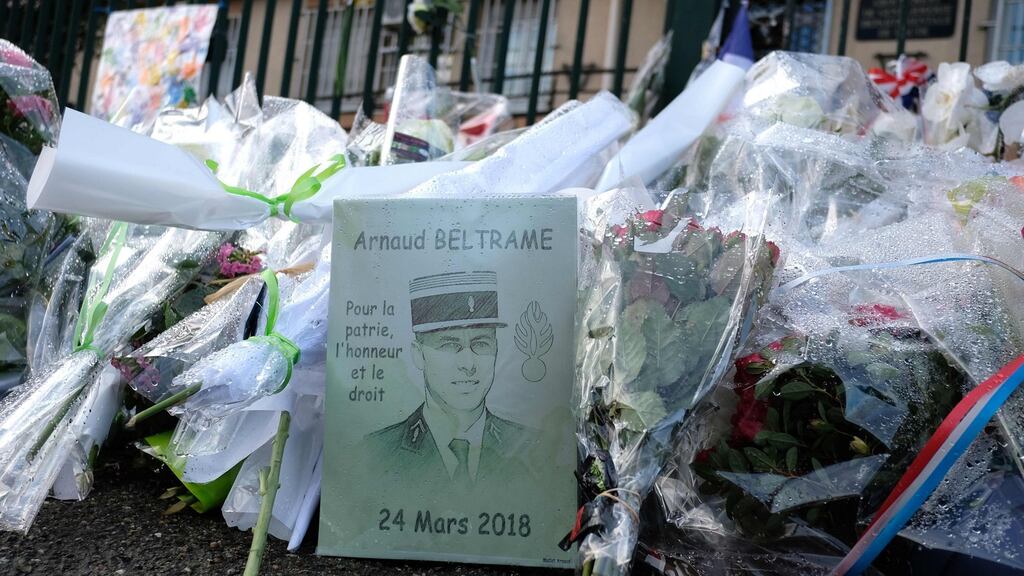 Tributes to Arnaud Beltrame killed in jihadist attack are pictured in front of barracks of the gendarmerie on Wednesday. in Carcassonne. Photograph: Eric Cabaniseric/AFP/Getty