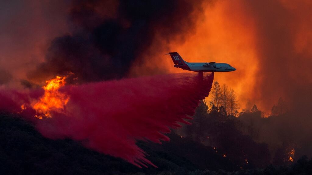A firefighting airplane drops fire retardant at the Holy Fire near Lake Elsinore, in Orange County, California. Photograph: David McNewAFP/Getty Images