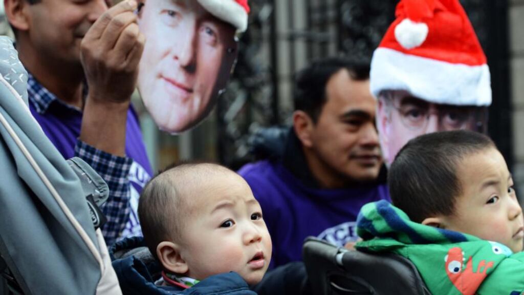 Children Zheng (8 months) and Jing (2 1/2) from Donegal, with family members attending the 24-hour vigil outside Leinster House. Photograph: Eric Luke