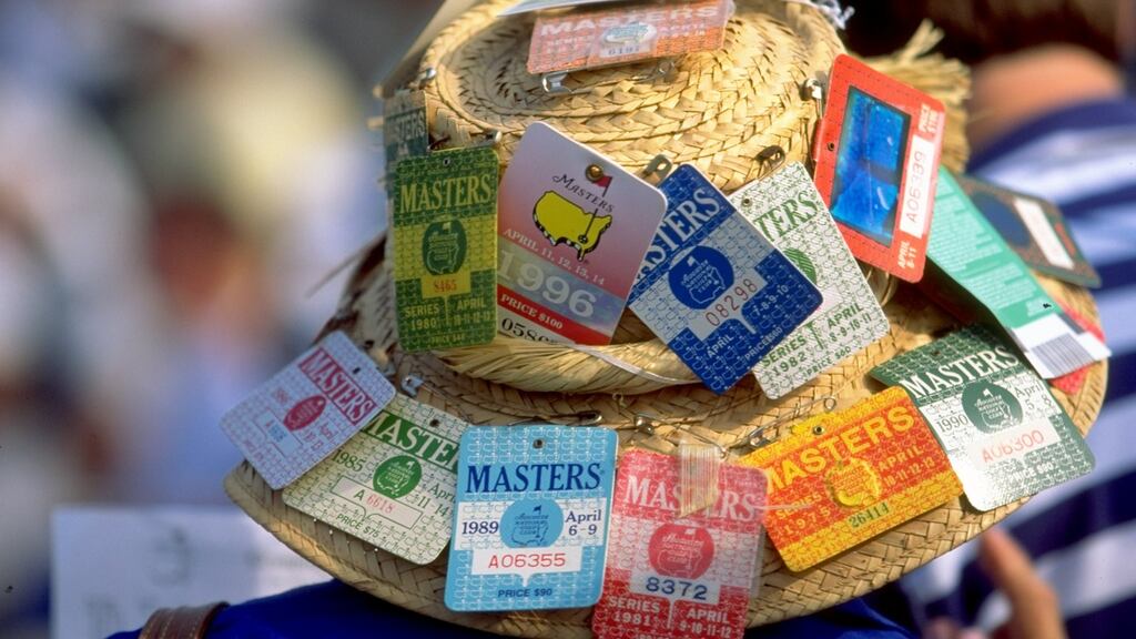 A masters fans displays the past entry tickets of the Masters on his hat. Photo: Craig Jones /Allsport
