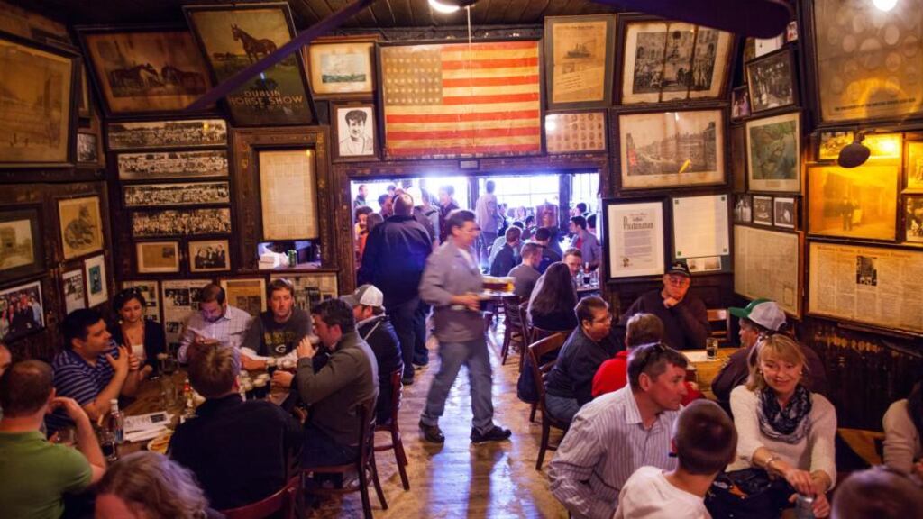 Richard Walsh, centre, serves beer. Photograph: Michael Nagle Richard Walsh, centre, serves beer. Photograph: Michael Nagle