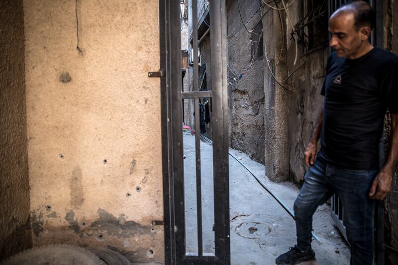 Ahmed points out bullet holes at the entrance to his family's home in Jenin refugee camp, which is regularly raided by Israeli security forces. Photograph: Sally Hayden