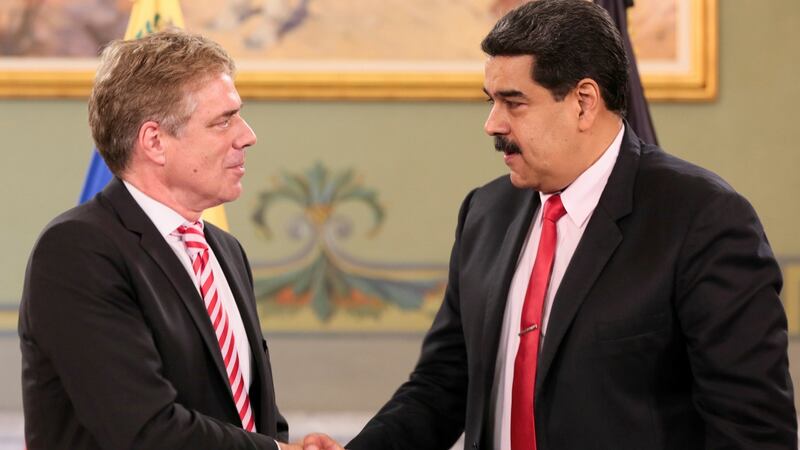 Venezuela’s president Nicolas Maduro (R) shakes hands with Germany’s ambassador to Venezuela Daniel Martin Kriener (L) in 2018 File Photograph: Miraflores Palace/ Reuters