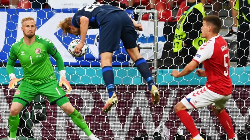 Finland’s Joel Pohjanpalo heads home the opening goal past Denmark goalkeeper Kasper Schmeichel at the Parken Stadium in Copenhagen. Photograph: Stuart Franklin/EPA
