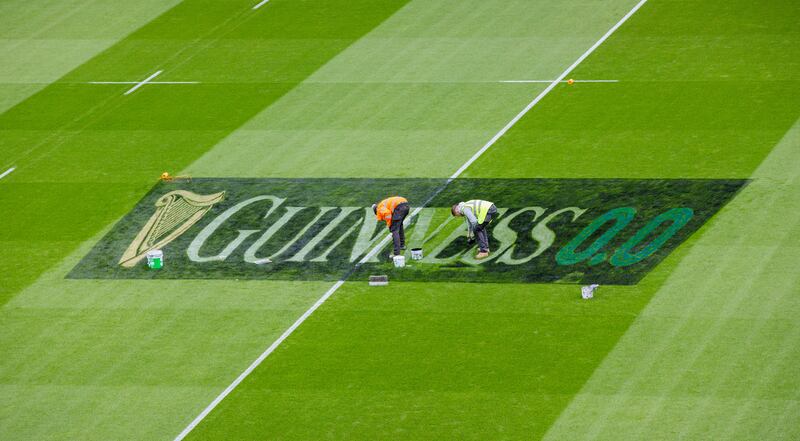 Guinness 0.0 branding being painted on the pitch at Aviva Stadium ahead of the Ireland-France match. James Crombie/Inpho