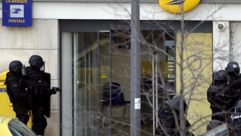French Research and Intervention Brigades policemen stand guard outside a post office where an armed man was holed up with two hostages, on January 16th, 2015 in Colombes, outside Paris, though there is no known link with last week’s jihadist attacks. Photograph: Kenzo Tribouillard/AFP/Getty Images