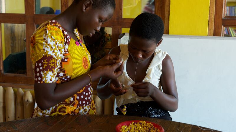 Children learn bead making at the Dream Big Community Center.