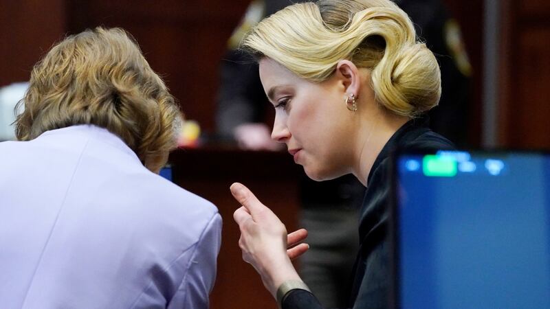Actor Amber Heard talks to her attorney in the courtroom at the Fairfax County Circuit Courthouse. Photograph: Steve Helber/EPA