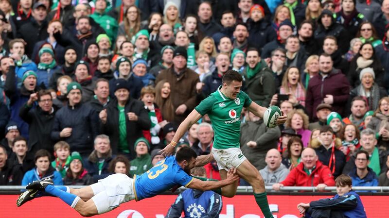 Ireland’s Jacob Stockdale breaks away from Italy’s Jayden Hayward to score his second try and Ireland’s eighth during the Six Nations match at the Avaiva stadium. Photograph: Brian Lawless/PA Wire