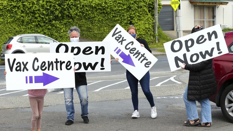 Volunteers hold signs during the Pasifika Youth Vax Festival at Cannons Creek Cage in Porirua, New Zealand. Photograph: Hagen Hopkins/Getty