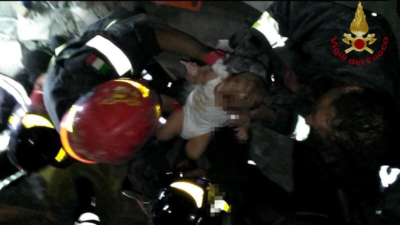 Firefighters saving a seven-month-old baby from rubble after an earthquake on Ischia island, Italy. Photograph: EPA