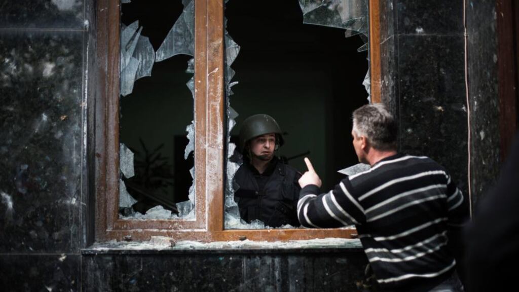 A pro-Russia activist 
is seen
 occupies  the prosecutor’s building after a pro Russia demonstration during International Worker’s Day in Donestsk, Ukraine.