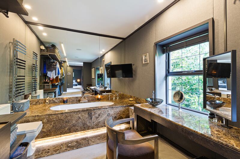 The main suite has his and her bathrooms and dressingrooms