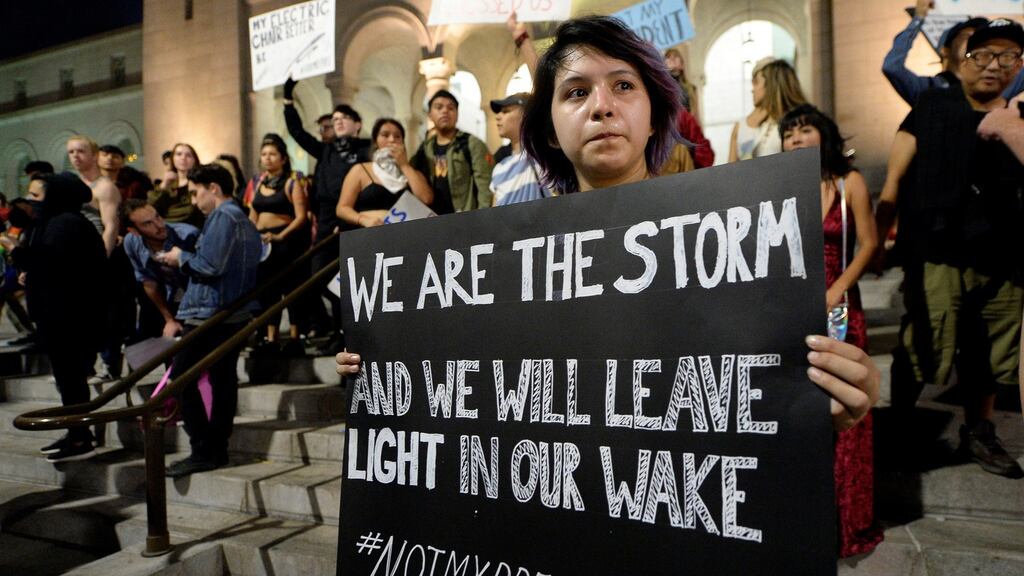 A protester holds a sign during a rally against the election of Republican Donald Trump as president in Los Angeles. Photograph: Kevork Djansezian/Reuters