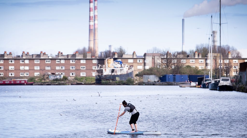 A man goes stand up paddleboarding at Grand Canal Dock, Dublin.Photograph: Tom Honan