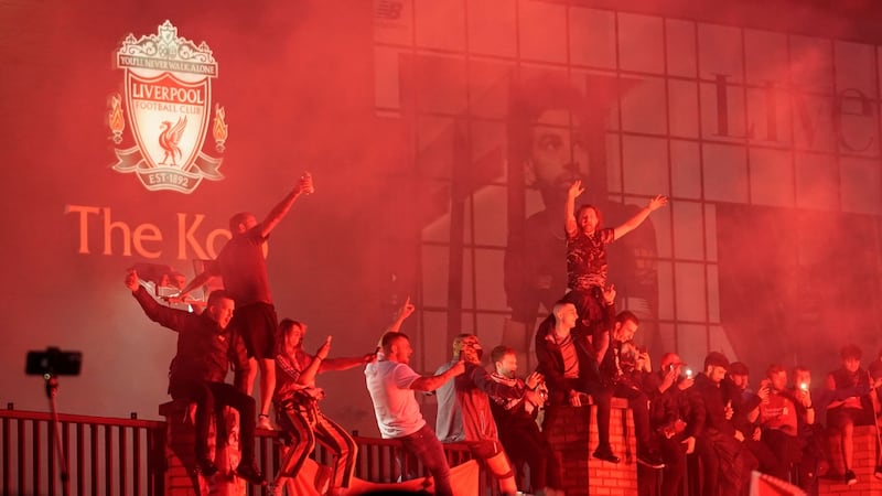 Liverpool fans celebrate outside The Kop stand at Anfield on Wednesday night. Photograph: Christopher Furlong/Getty Images