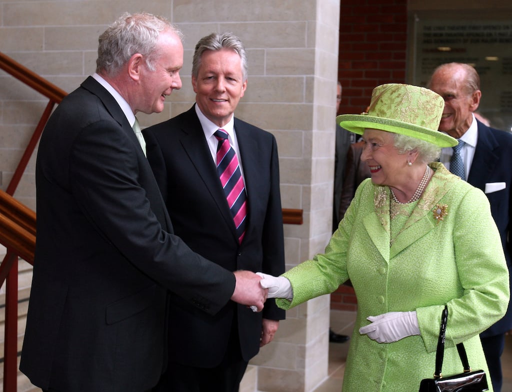 Queen Elizabeth II shakes hands with Sinn Féin Deputy First Minister of Northern Ireland Martin McGuinness watched by DUP First Minister Peter Robinson at the Lyric Theatre in Belfast in June 2012. Photograph: Paul Faith/WPA Pool/Getty Images