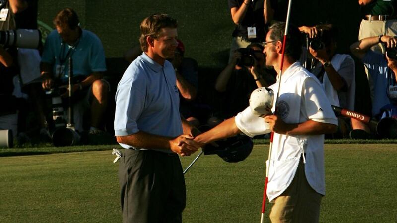 Goosen is congratulated on the 18th green by caddie Colin Bryne. Photo: Ezra Shaw/Getty Images