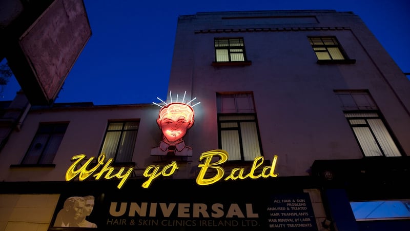 The iconic neon sign on the side of the Universal Hair and Scalp clinic in South Great George’s Street, Dublin