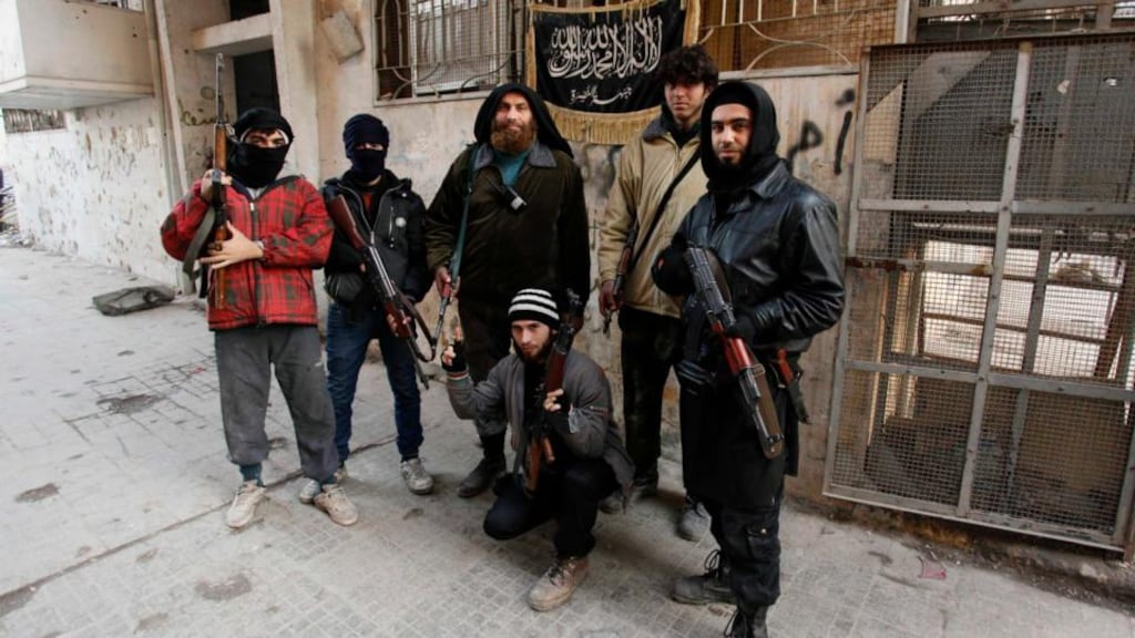 Members of Islamist Syrian rebel group Jabhat al-Nusra pose at a checkpoint at the Karaj al-Hajez crossing, a passageway separating Aleppo’s Bustan al-Qasr, which is under the rebels’ control, and Al-Masharqa neighbourhoods, an area controlled by the Assad regime. Photograph: Reuters/Molhem Barakat