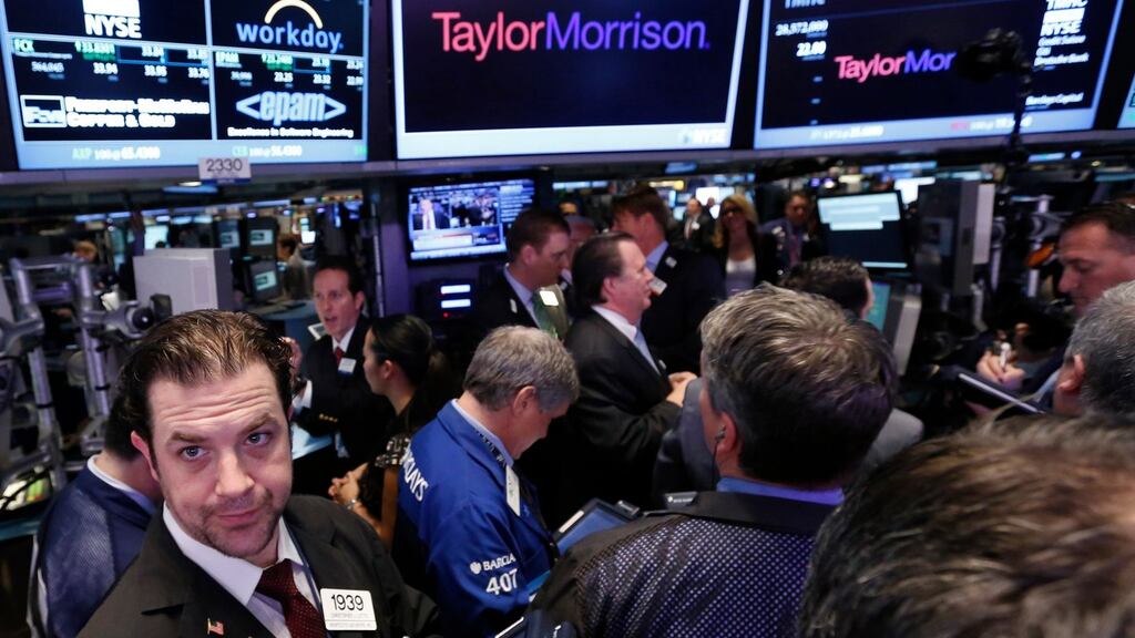 Traders gather for the initial public offering of Taylor Morrison on the floor at the New York Stock Exchange. Photograph: Brendan McDermid/Reuters