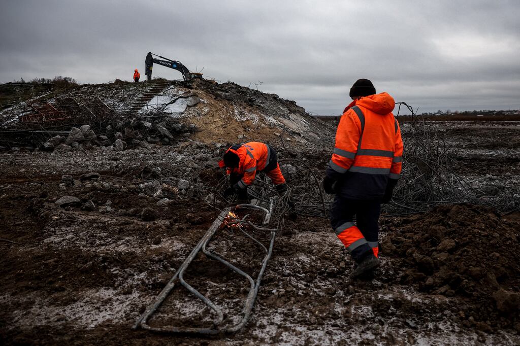 Workers repair a destroyed bridge, blown up by Russian troops during their retreat from the Kherson region. Photograph: ANATOLII STEPANOV/AFP via Getty Images