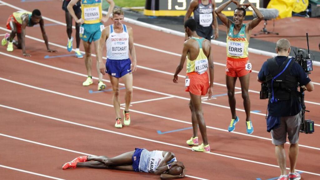 Britain’s Mo Farah reacts on the track after coming in second to take silver as Ethiopia’s Muktar Edris (right) does Farah’s trademark ‘Mobot’ gesture as he celebrates his win. Photograph: Adrian Dennis/AFP/Getty Images