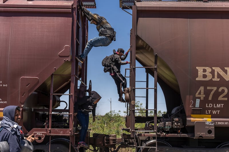 Venezuelan migrants decend from a freight train following their journey toward the US-Mexico border in Ciudad Juárez. Photograph: Alejandro Cegarra/New York Times